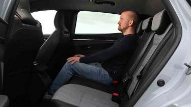 Renault Megane E-Tech - rear seats with Auto Express Chief reviewer, Alex Ingram